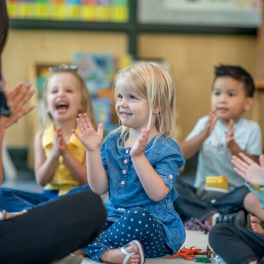 Kids interacting and waving at teacher.