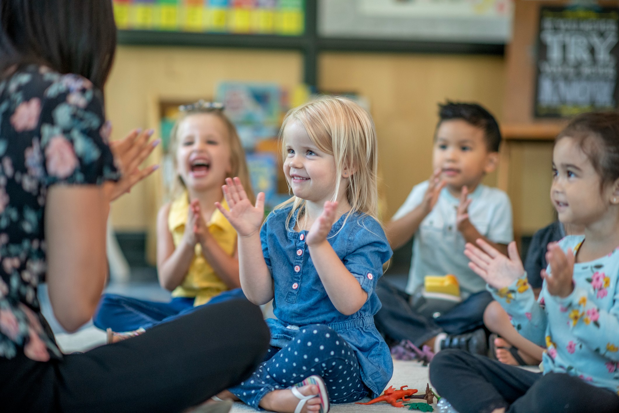 Kids interacting and waving at teacher.
